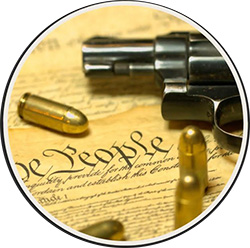 handgun with bullets and U.S. Constitution