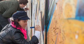 Tourists sign the 'peace wall' in Belfast in 2014.