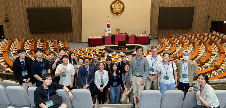 Students pose in a group at the Korean National Assembly