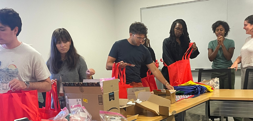 Volunteers assemble care packages during Public Service Day events